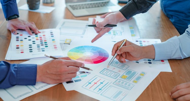 Creative web designers and applications work together in the office.