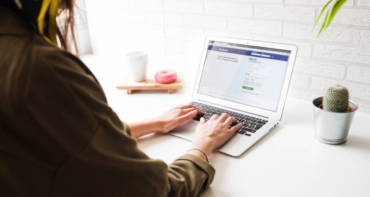 woman-login-into-facebook-website-on-laptop